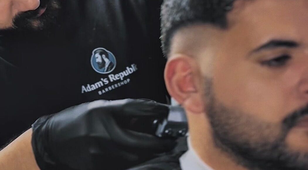 Barber at Adam's Republic | Al-Shati in Dammam, المنطقة الشرقية, SA skillfully trims a client's hair.