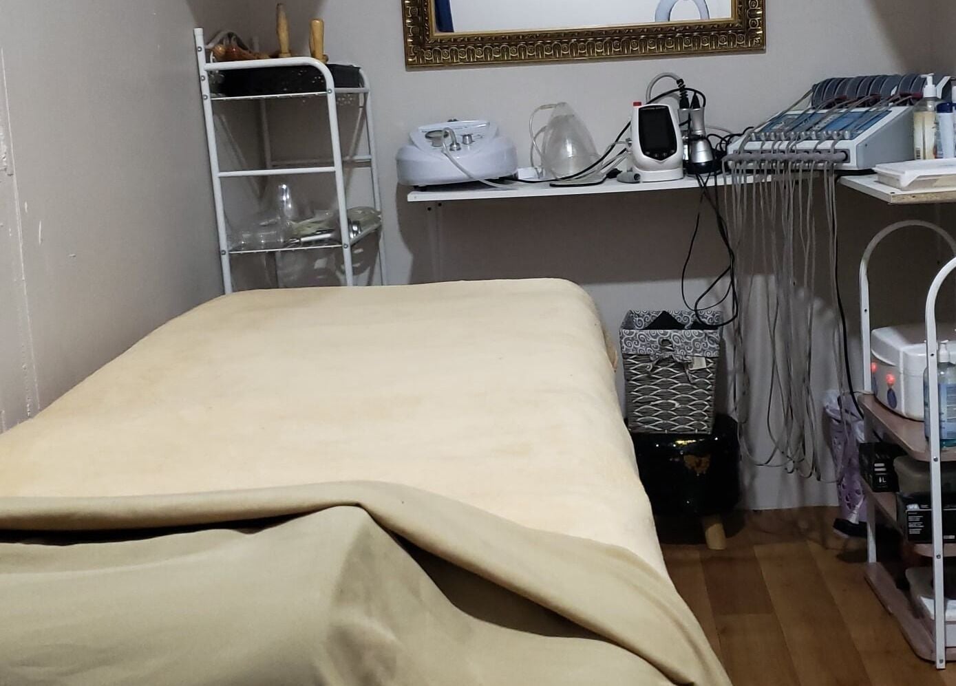 Relaxing treatment room at InnoSense Salon and Med Spa in St. James, TT, featuring a comfortable bed.