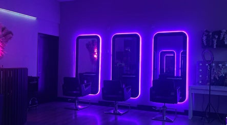 Chic neon-lit salon interior at Blossom Beauty, Dublin, County Dublin, IE, featuring stylish mirrors and chairs.