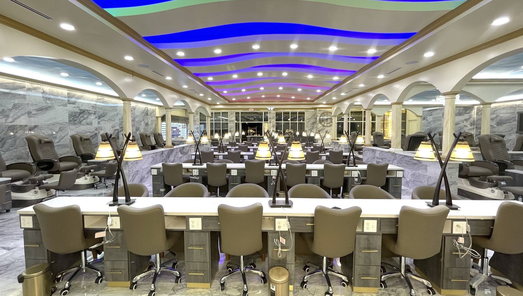 Luxurious interior of Luminous V Nail Spa in Springboro, Ohio, US, featuring modern nail stations and ambient lighting.