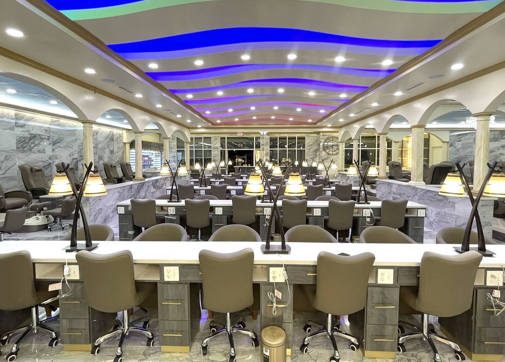 Luxurious interior of Luminous V Nail Spa in Springboro, Ohio, US, featuring modern nail stations and ambient lighting.