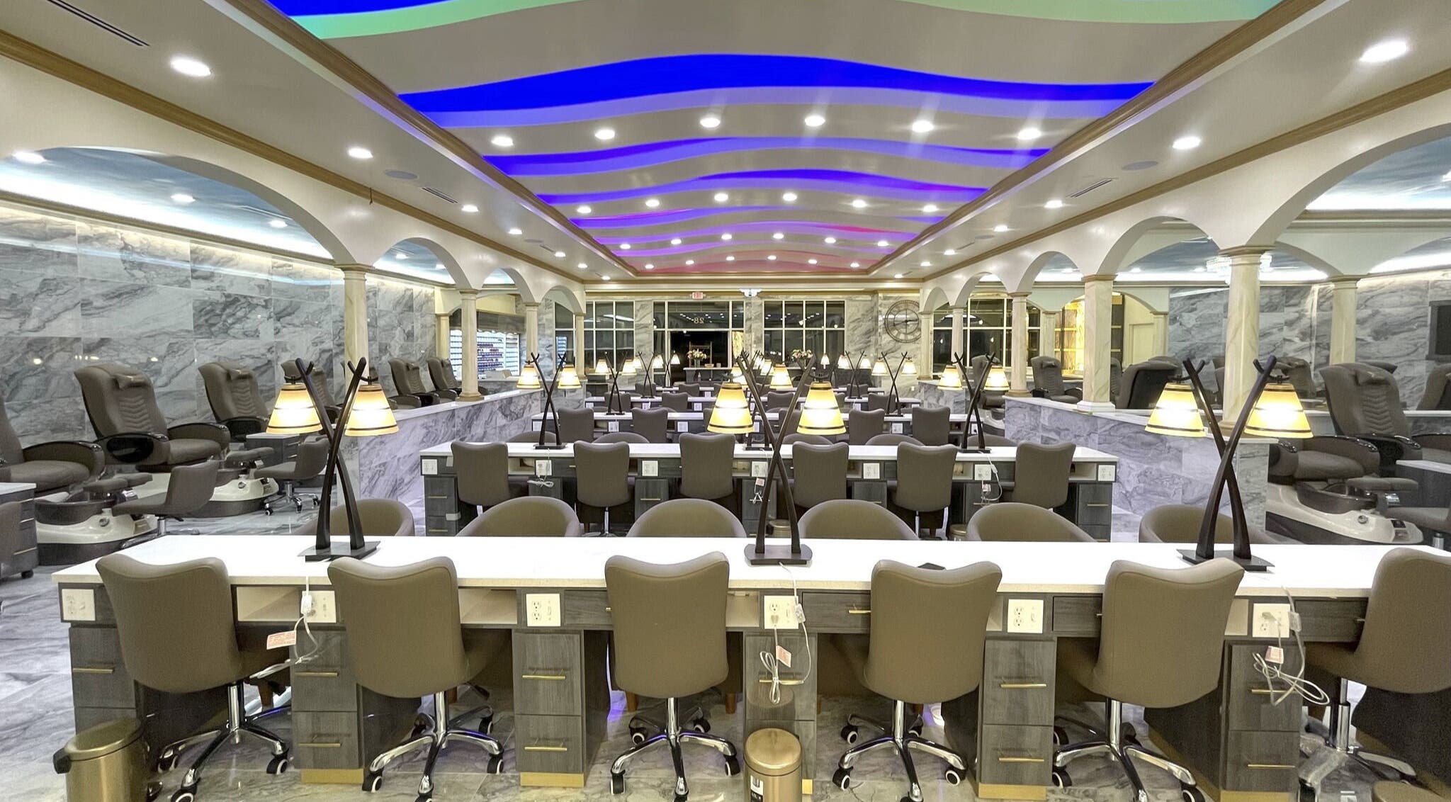 Luxurious interior of Luminous V Nail Spa in Springboro, Ohio, US, featuring modern nail stations and ambient lighting.