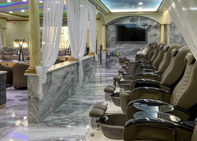 Elegant interior of Luminous V Nail Spa in Springboro, Ohio, US with plush pedicure chairs and marble decor.