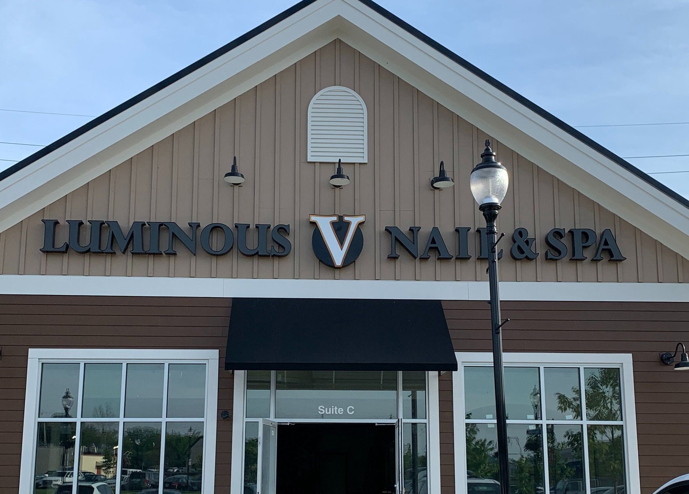 Front view of Luminous V Nail Spa in Springboro, Ohio, US showcasing its elegant brown exterior.
