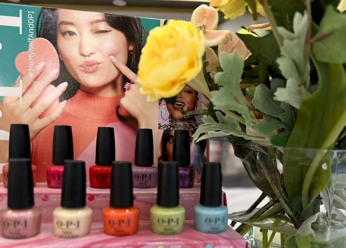 Colorful OPI nail polishes at Luminous V Nail Spa in Springboro, Ohio, US with floral decor.