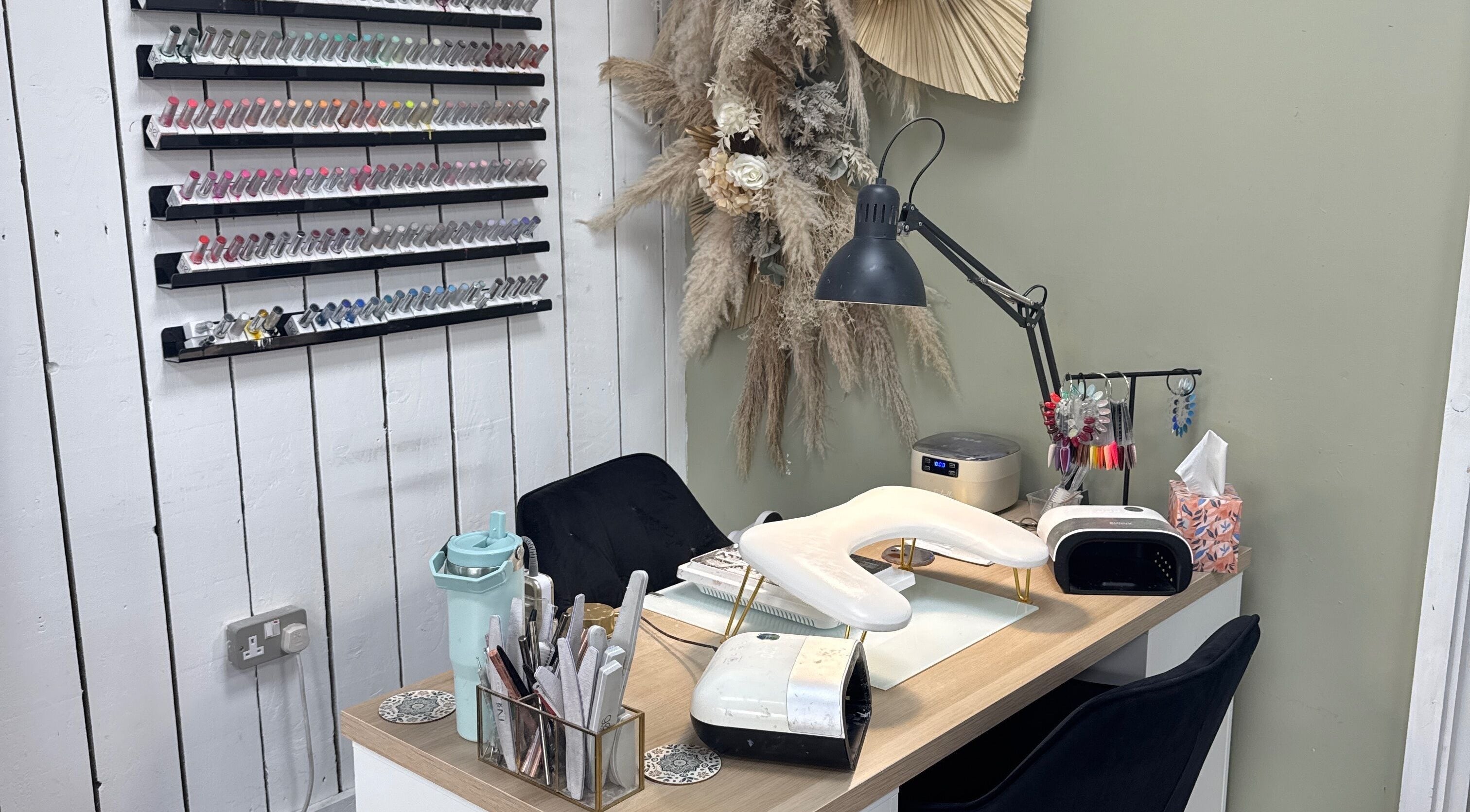 Cozy nail station at Nails by Lia in Wednesbury, England with elegant decor and nail polish display.