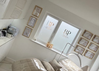 Bright, elegant treatment room at RP Studios, Milnrow, England, GB with awards and modern decor.