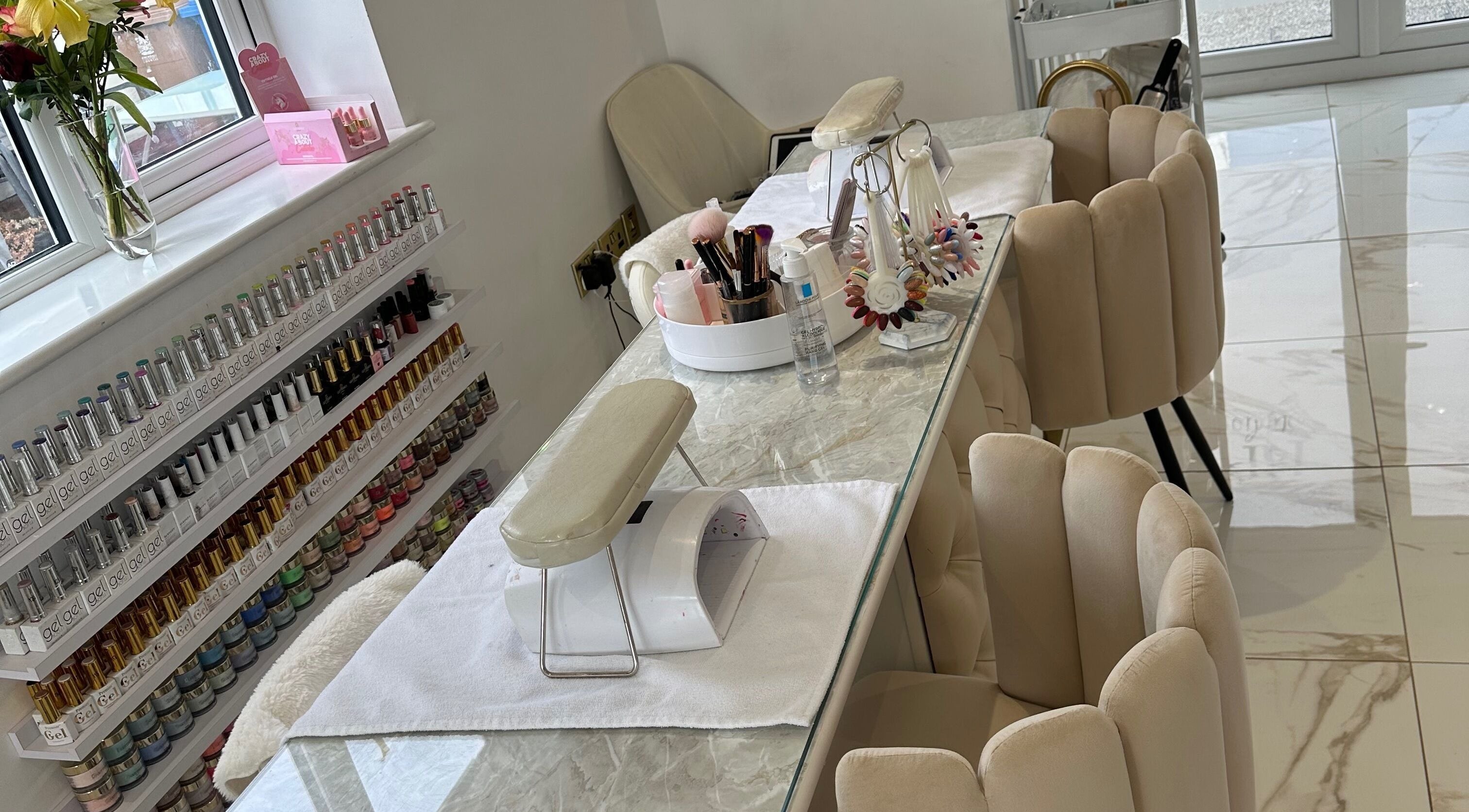 Ultra-modern nail salon setup at RP Studios in Milnrow, England, GB with elegant chairs and nail polish display.