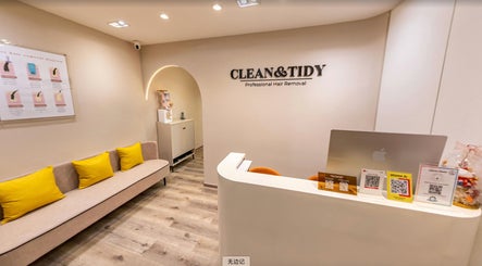 Reception area of Clean and Tidy Orchard, Singapore showing cozy seating and minimalistic decor.