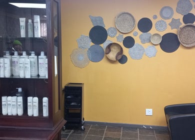 Chic wall decor and hair products at New Millennium Hair Studio, Lydenburg, Mpumalanga, ZA.