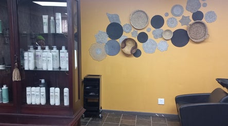 Chic wall decor and hair products at New Millennium Hair Studio, Lydenburg, Mpumalanga, ZA.