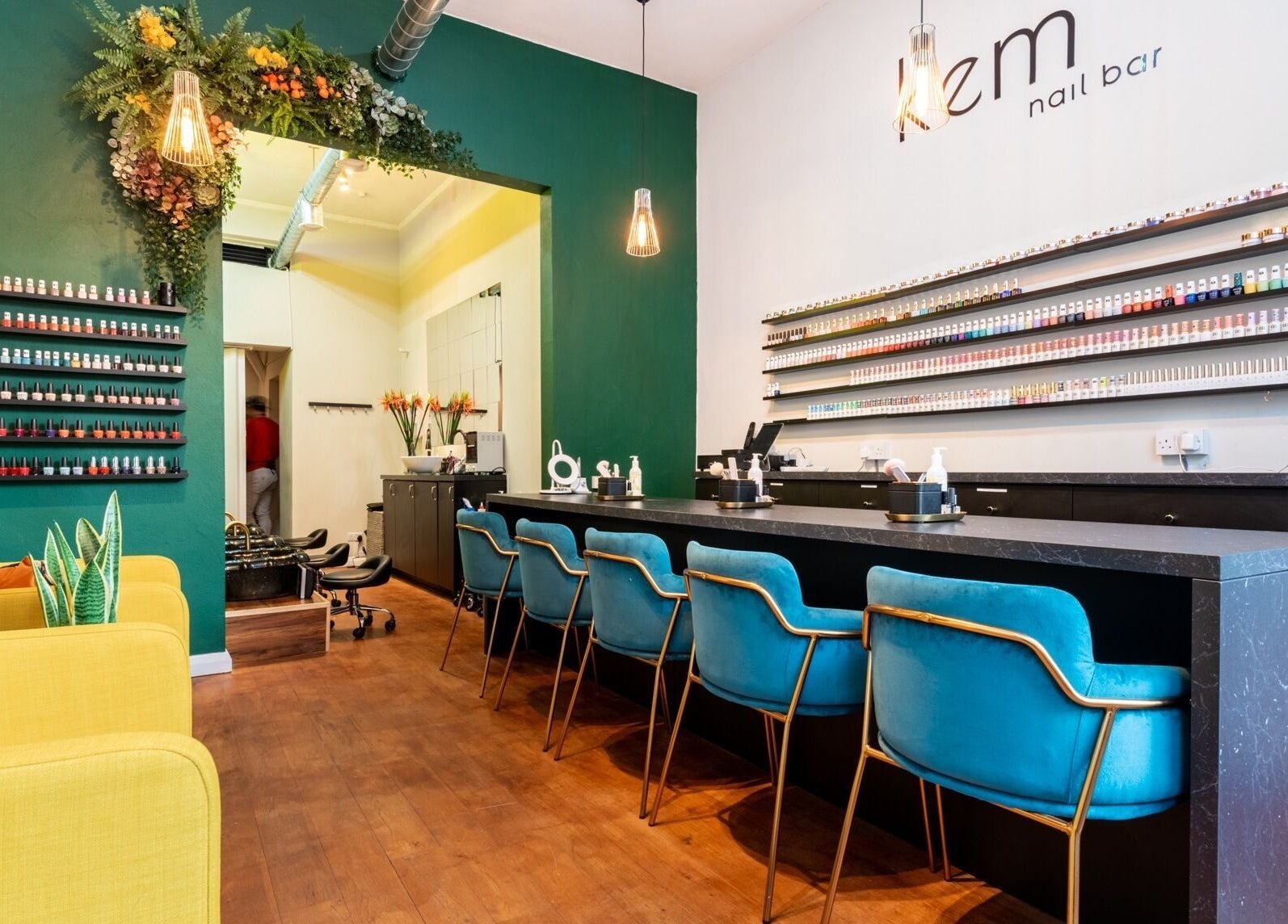 Chic interior of Kem Nail Bar in London, England, GB with vibrant seating and nail polish displays.