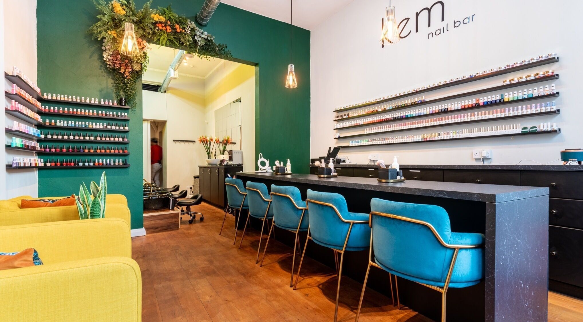 Chic interior of Kem Nail Bar in London, England, GB with vibrant seating and nail polish displays.