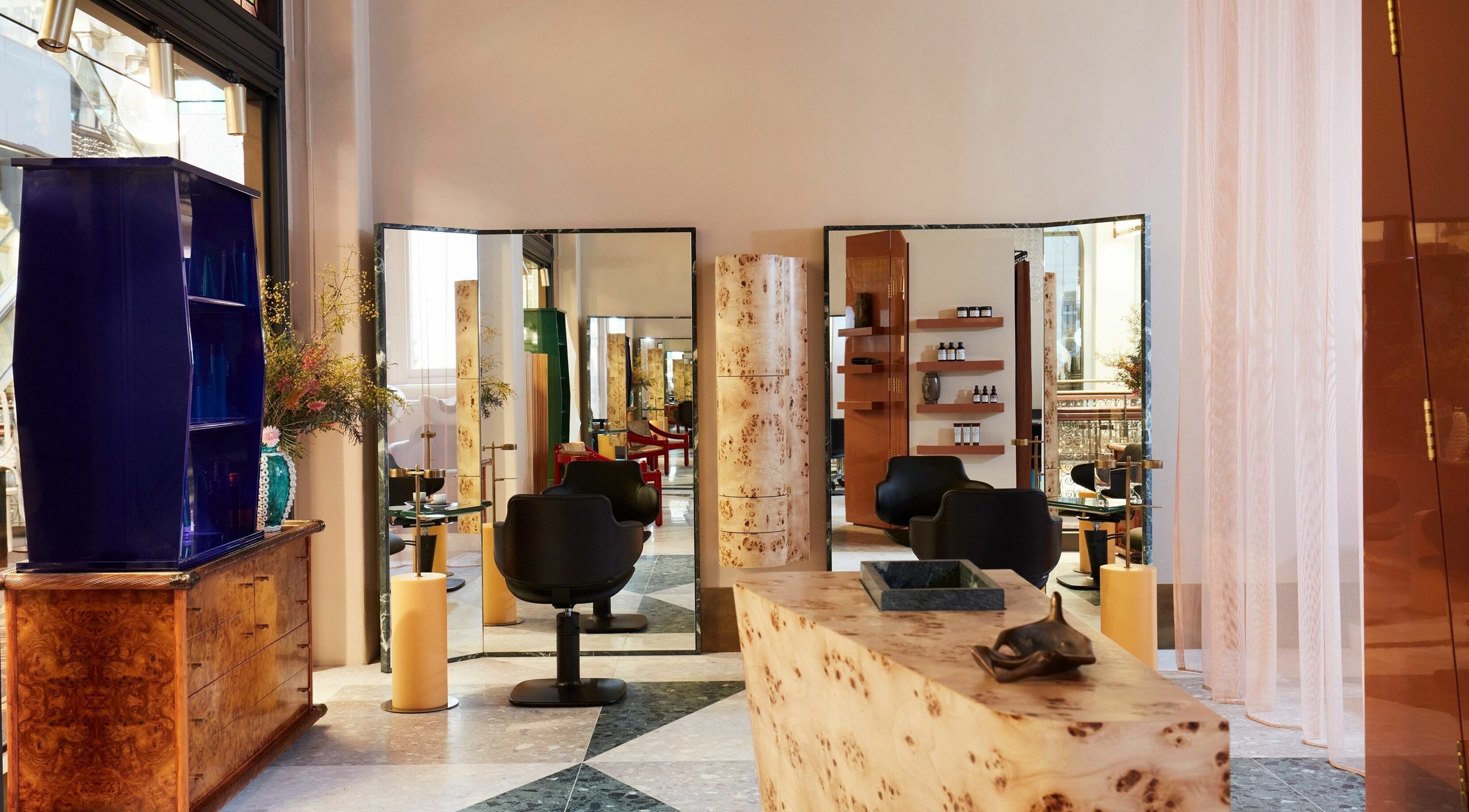 Elegant interior of Koda Cutters - QVB, Sydney, New South Wales, AU with stylish chairs and mirrors.