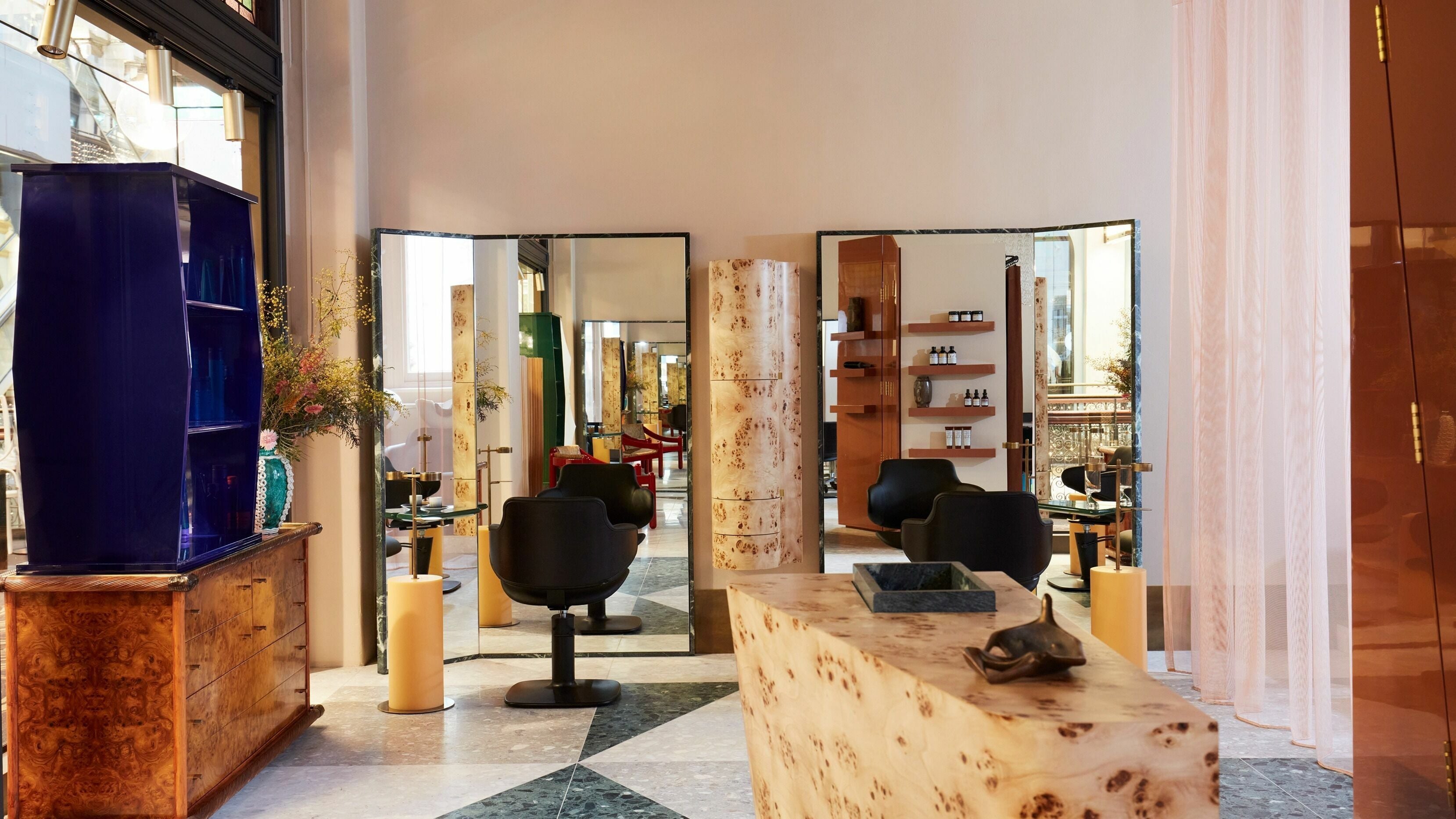 Elegant interior of Koda Cutters - QVB, Sydney, New South Wales, AU with stylish chairs and mirrors.