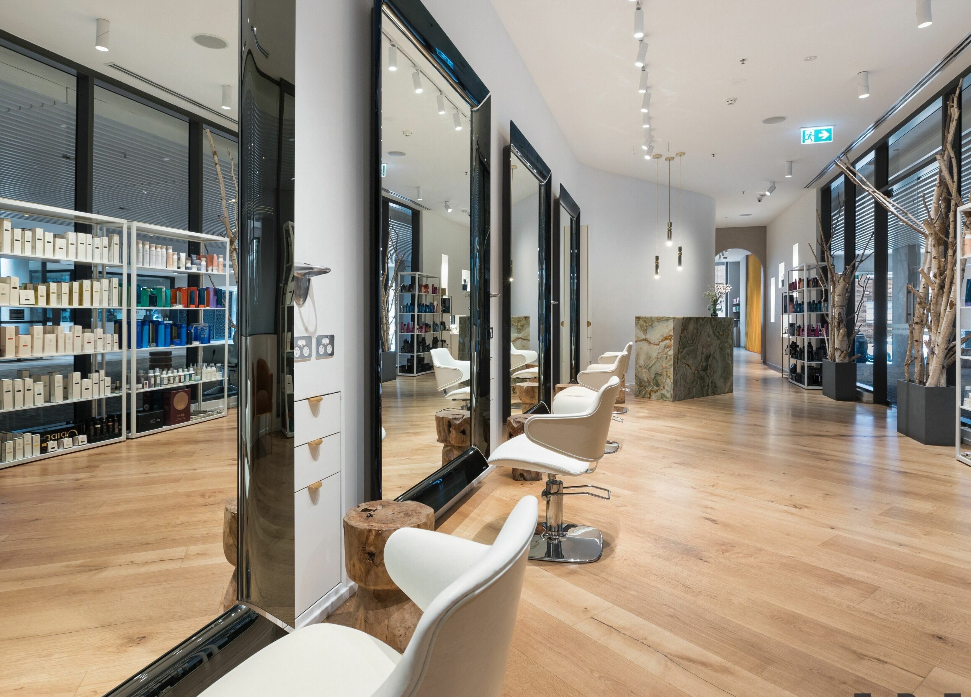 Interior of Koda Cutters - Bondi in Bondi Beach, showcasing chic salon chairs and a luxurious product display.