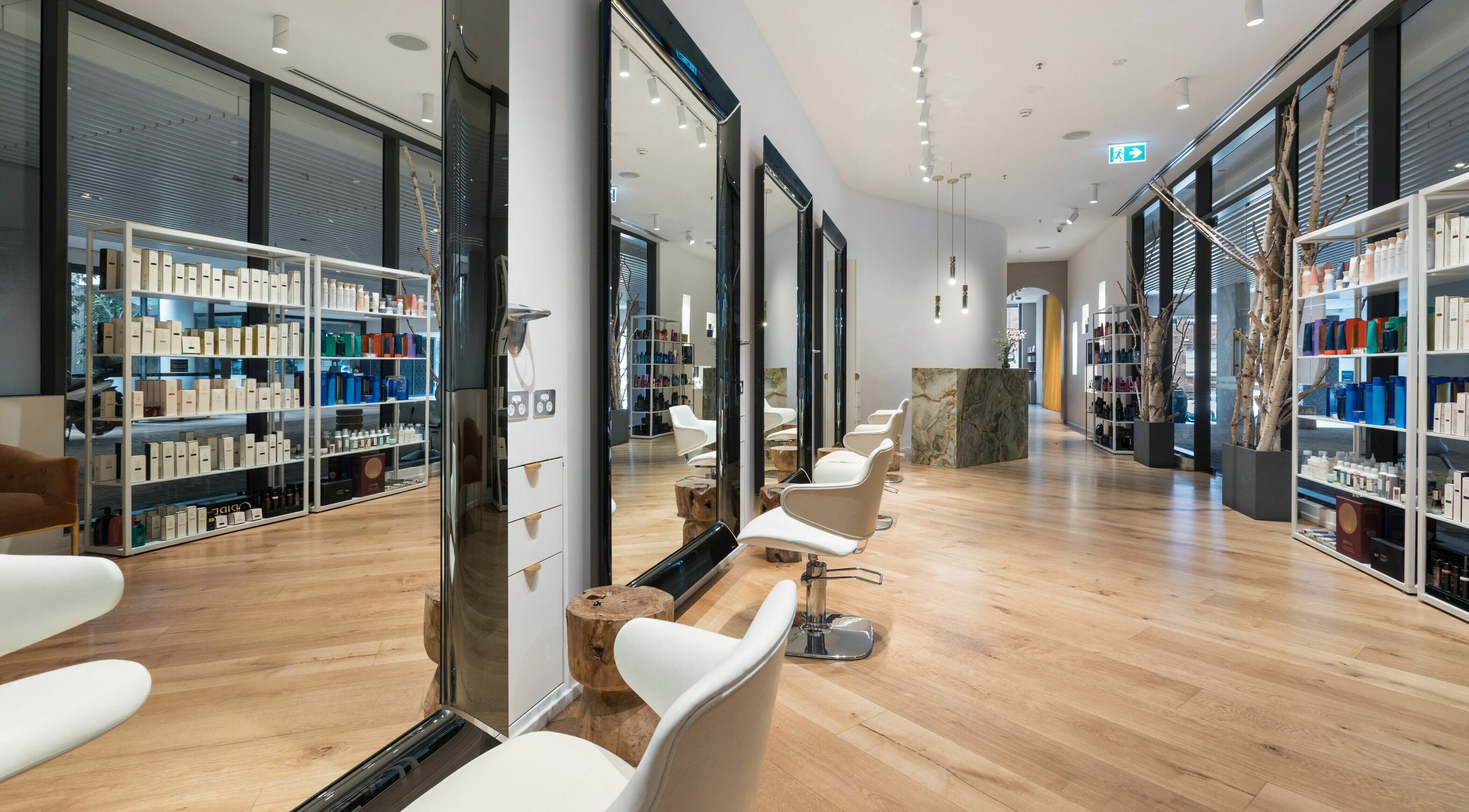 Interior of Koda Cutters - Bondi in Bondi Beach, showcasing chic salon chairs and a luxurious product display.