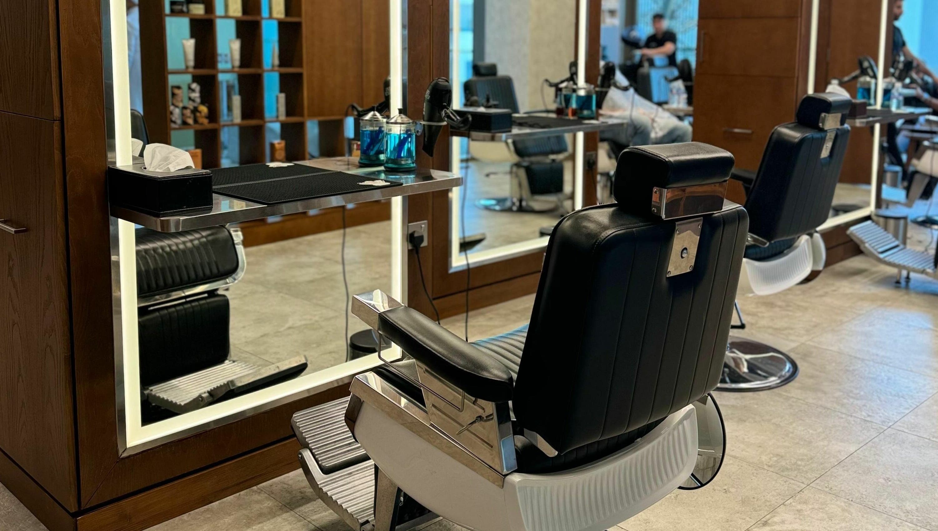 Modern barber chairs at Barber Bros, Dubai, AE with a stylish interior design.