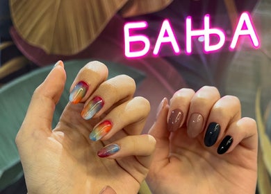 Colorful nail art showcased at Studio Banja, Београд, RS, featuring neon sign background.