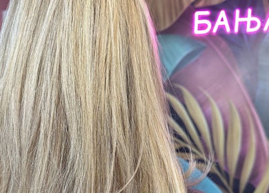 Blonde hair with vibrant neon sign at Studio Banja, Београд, RS, showcasing modern beauty ambiance.