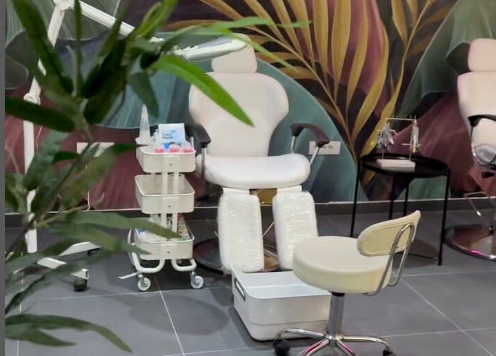 Pedicure station at Studio Banja, Београд, RS, with vibrant wall art and comfortable seating.