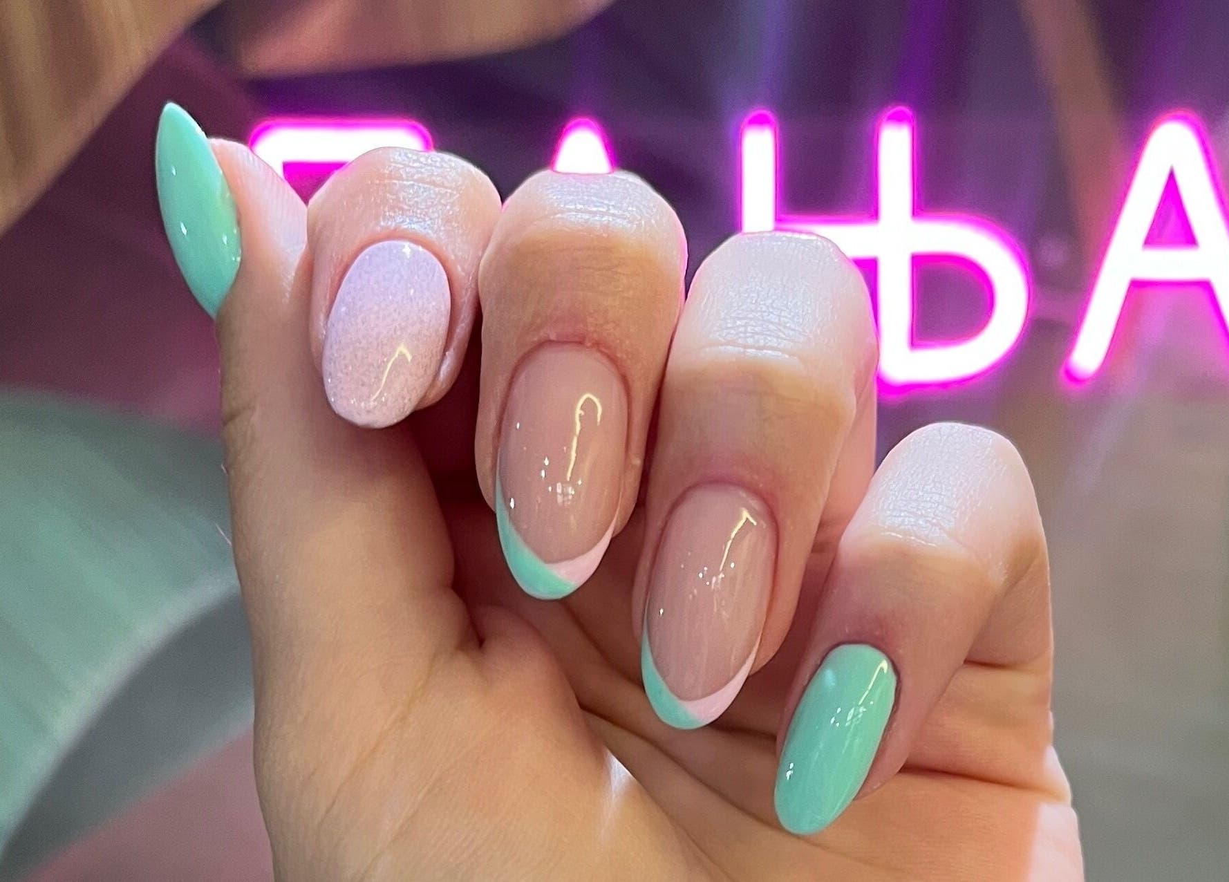 Gorgeous pastel manicured nails at Studio Banja, Београд, RS illuminated by a neon sign.