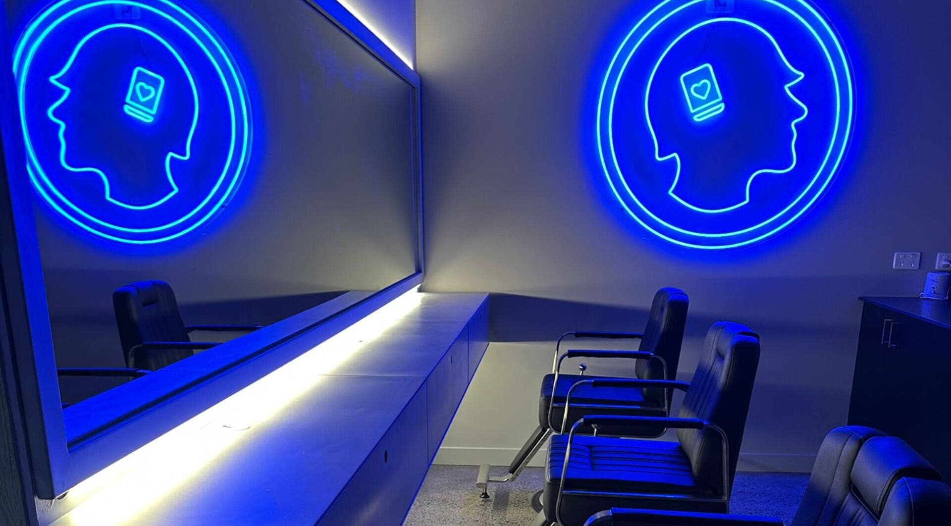 Modern seating area with neon art at Hearts & Minds Tuggerah (World Gym), Tuggerah, New South Wales, AU.