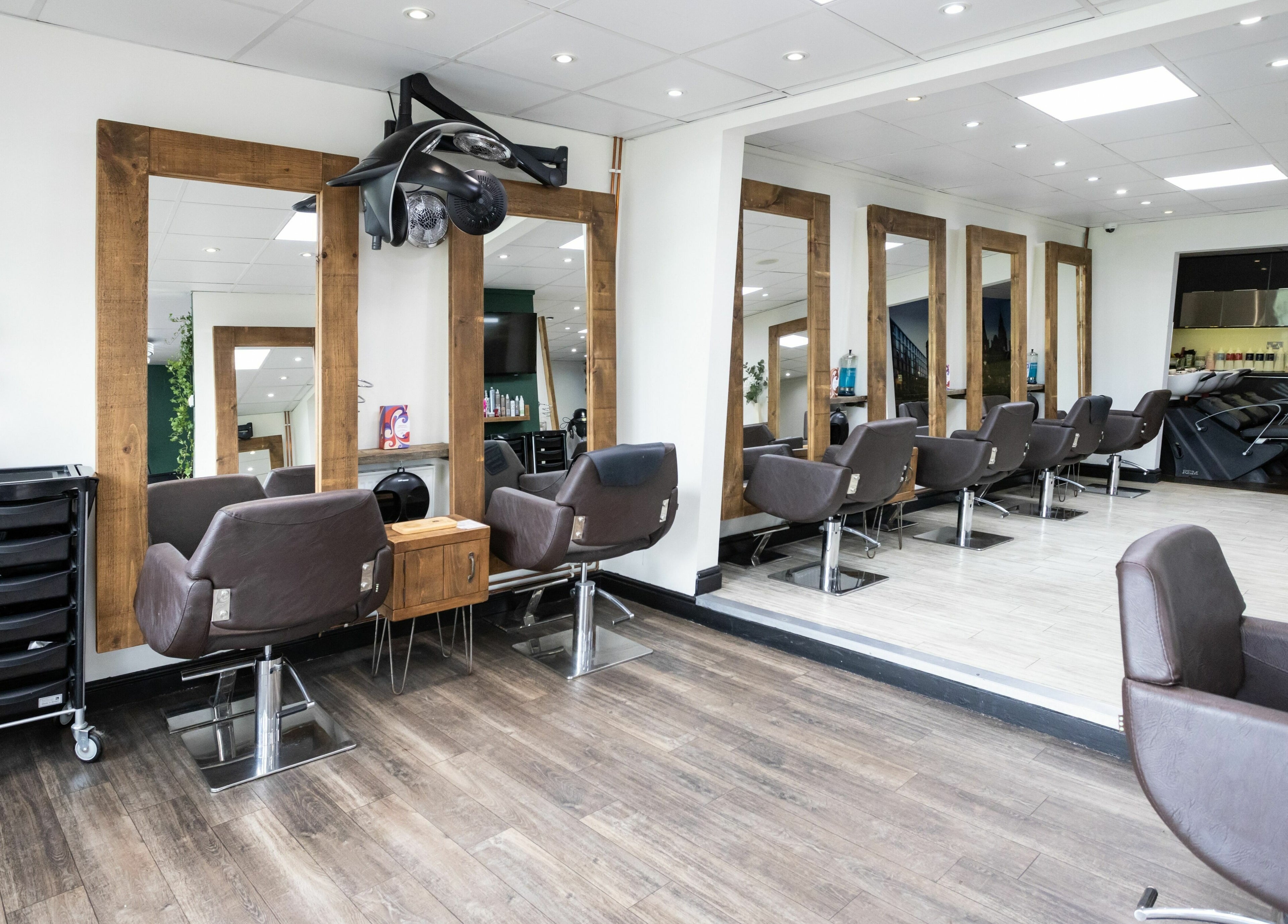 Modern hair salon at Headlines Elite, Sheffield, England, GB with chic styling chairs and mirrors.