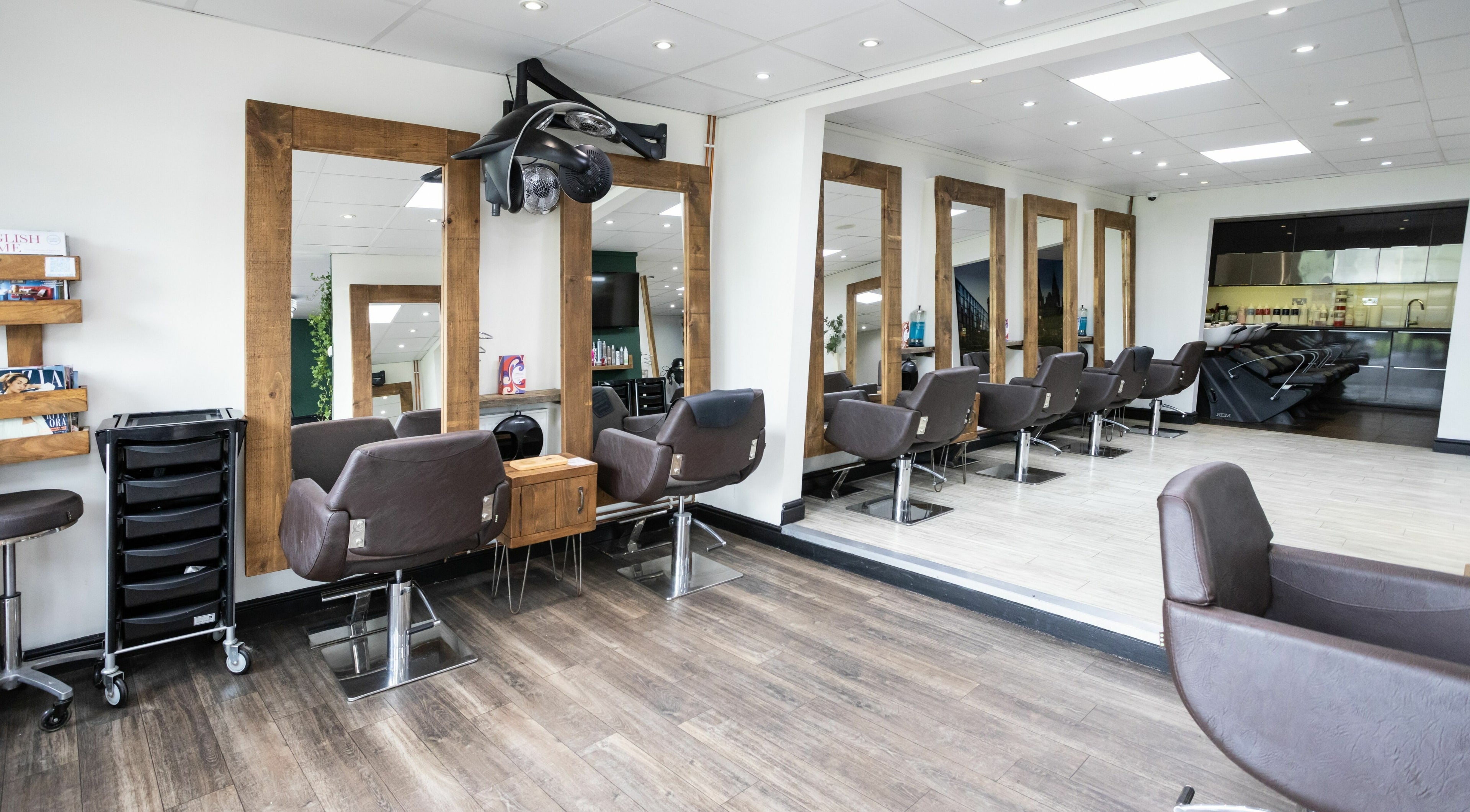 Modern hair salon at Headlines Elite, Sheffield, England, GB with chic styling chairs and mirrors.
