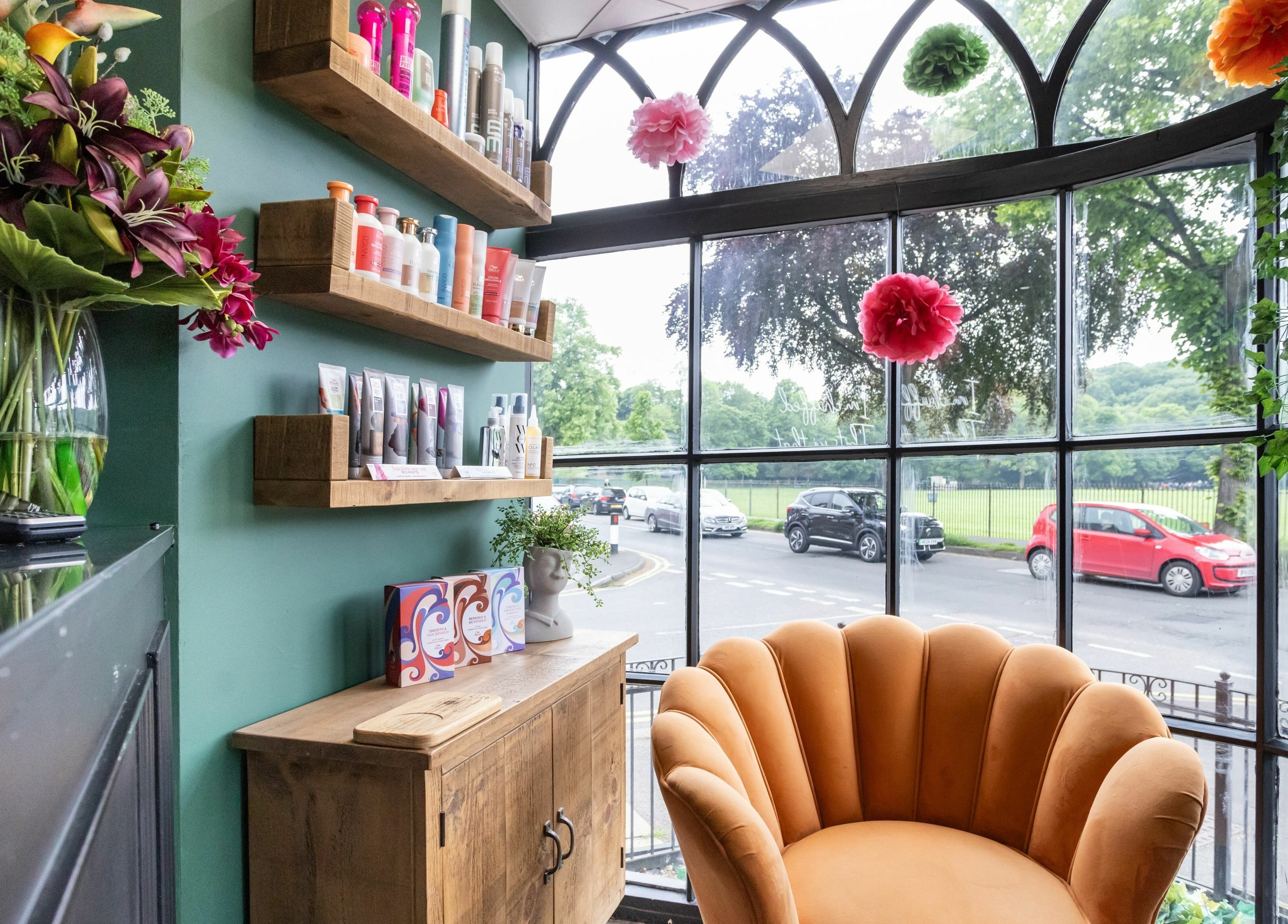 Inviting lounge area at Headlines Elite, Sheffield, England, GB, featuring stylish seating and beauty products.
