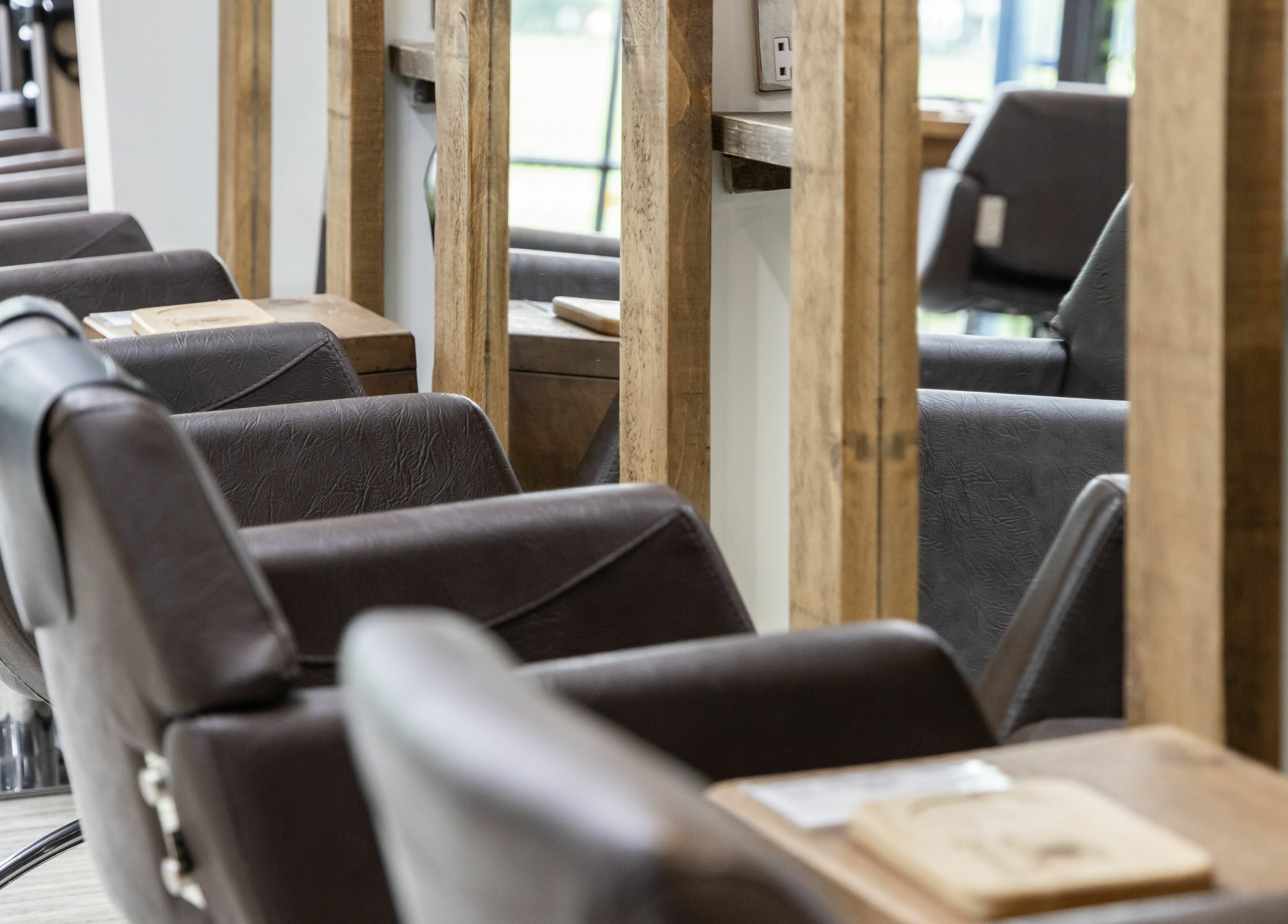 Stylish salon chairs at Headlines Elite, Sheffield, England, GB, offer a luxurious experience.