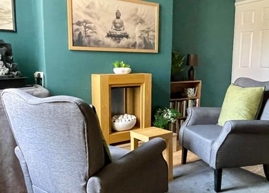 Tranquil lounge area at Yakushi Healing Centre, Sandiacre, England, with serene decor and comfortable seating.