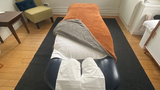 Tranquil massage room at Divine Alchemy Dunedin, featuring a cozy bed setup in Dunedin, Otago, NZ.