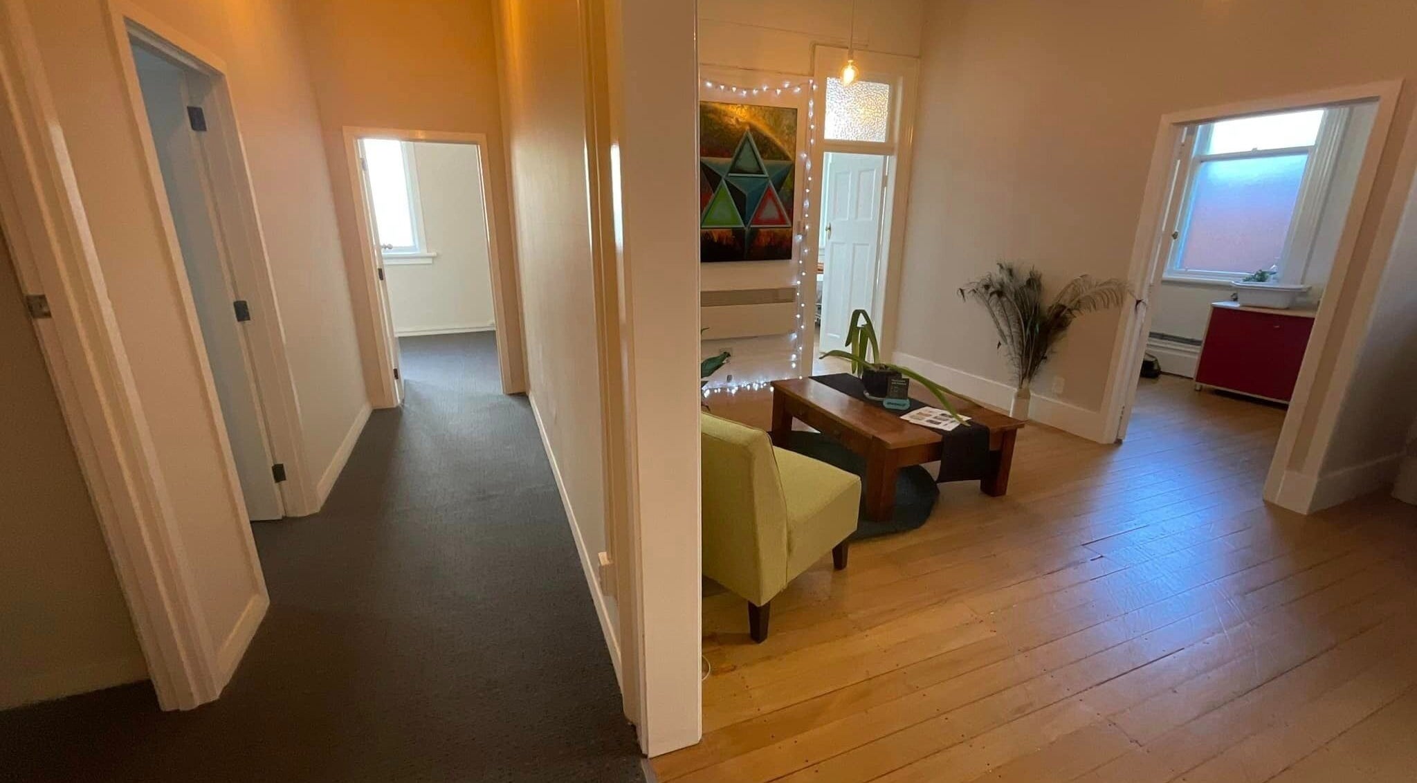 Inviting interior of Divine Alchemy Dunedin in Dunedin, Otago, NZ, featuring warm lighting and cozy seating.