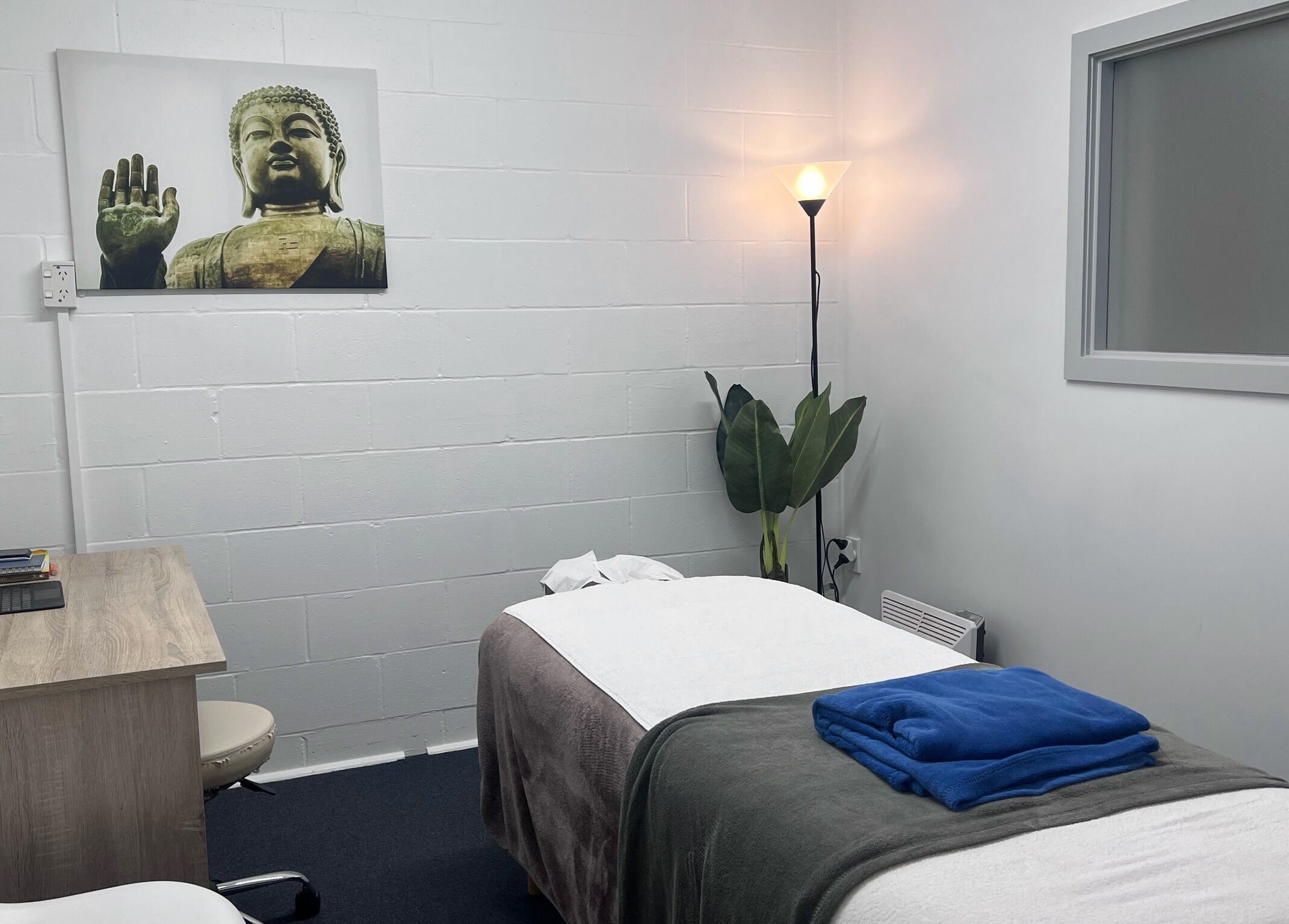 Relaxing massage room at Divine Alchemy Winton, Winton, Southland, NZ, featuring serene decor and ambiance.