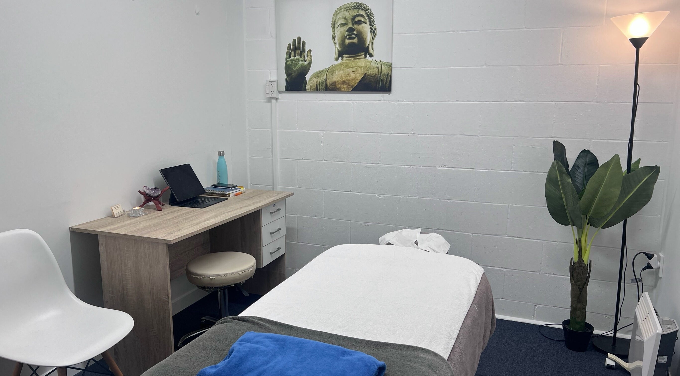 Serene massage room at Divine Alchemy Winton, Winton, Southland, NZ featuring calming decor and warm lighting.