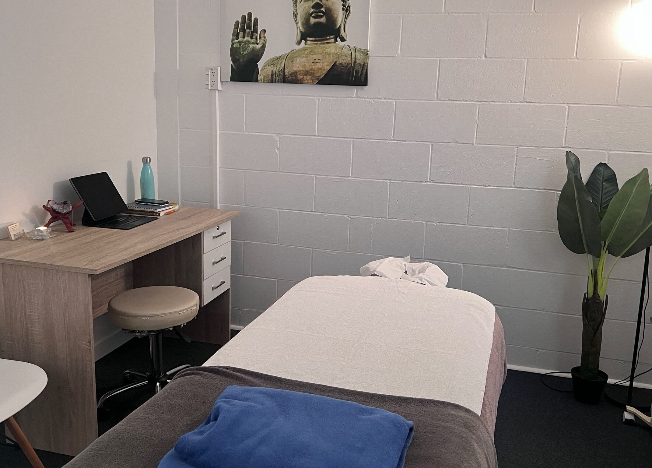 Calm massage room at Divine Alchemy Winton, Winton, Southland, NZ, featuring a treatment bed and decor.