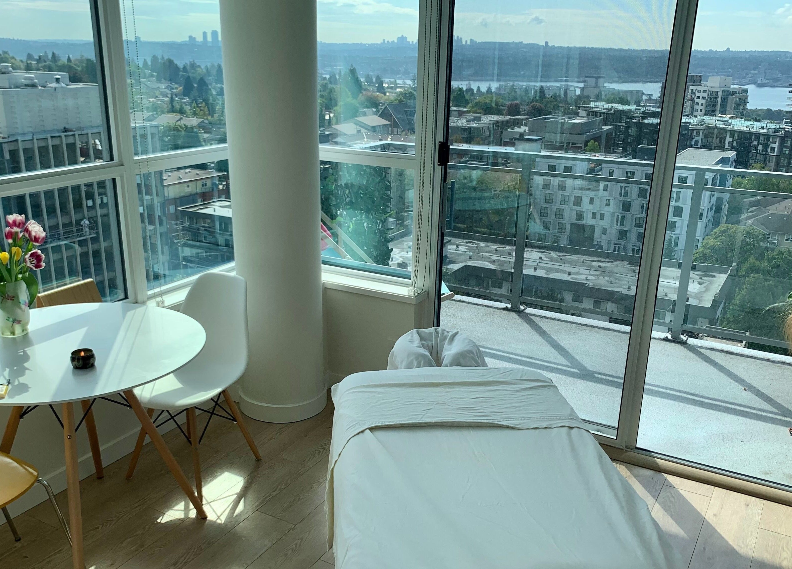 Relaxing massage room at En Vie Mobile Massage, Vancouver, British Columbia, CA, with city view.