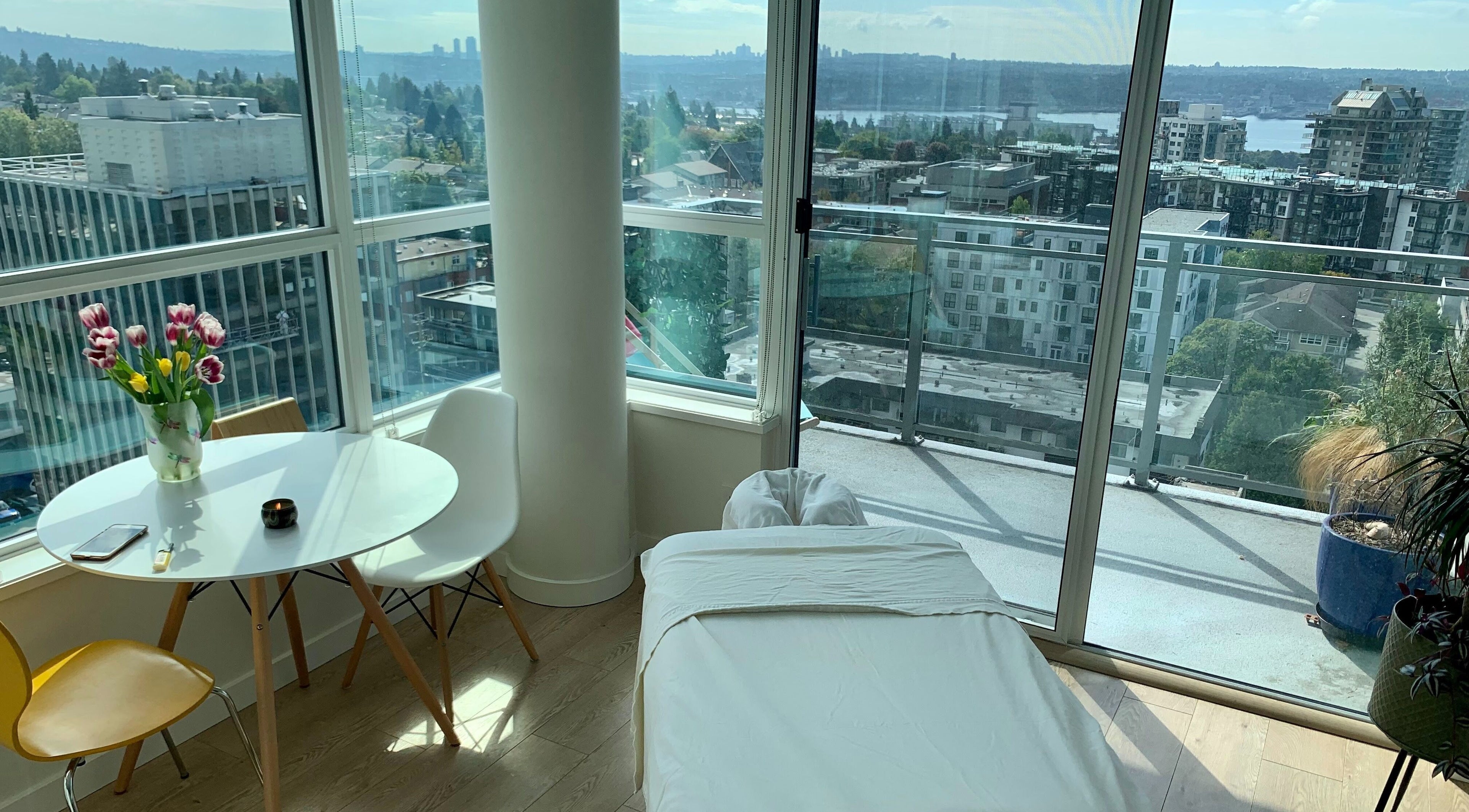 Relaxing massage room at En Vie Mobile Massage, Vancouver, British Columbia, CA, with city view.