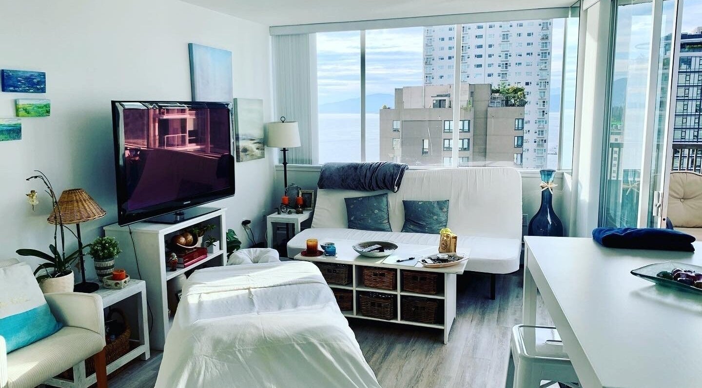 Serene living room setup at En Vie Mobile Massage in Vancouver, British Columbia, CA with a stunning city view.