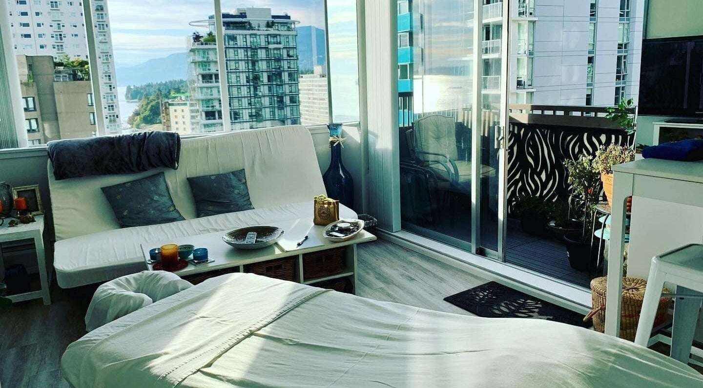 Relaxing massage room at En Vie Mobile Massage, Vancouver, BC, with stunning city views.