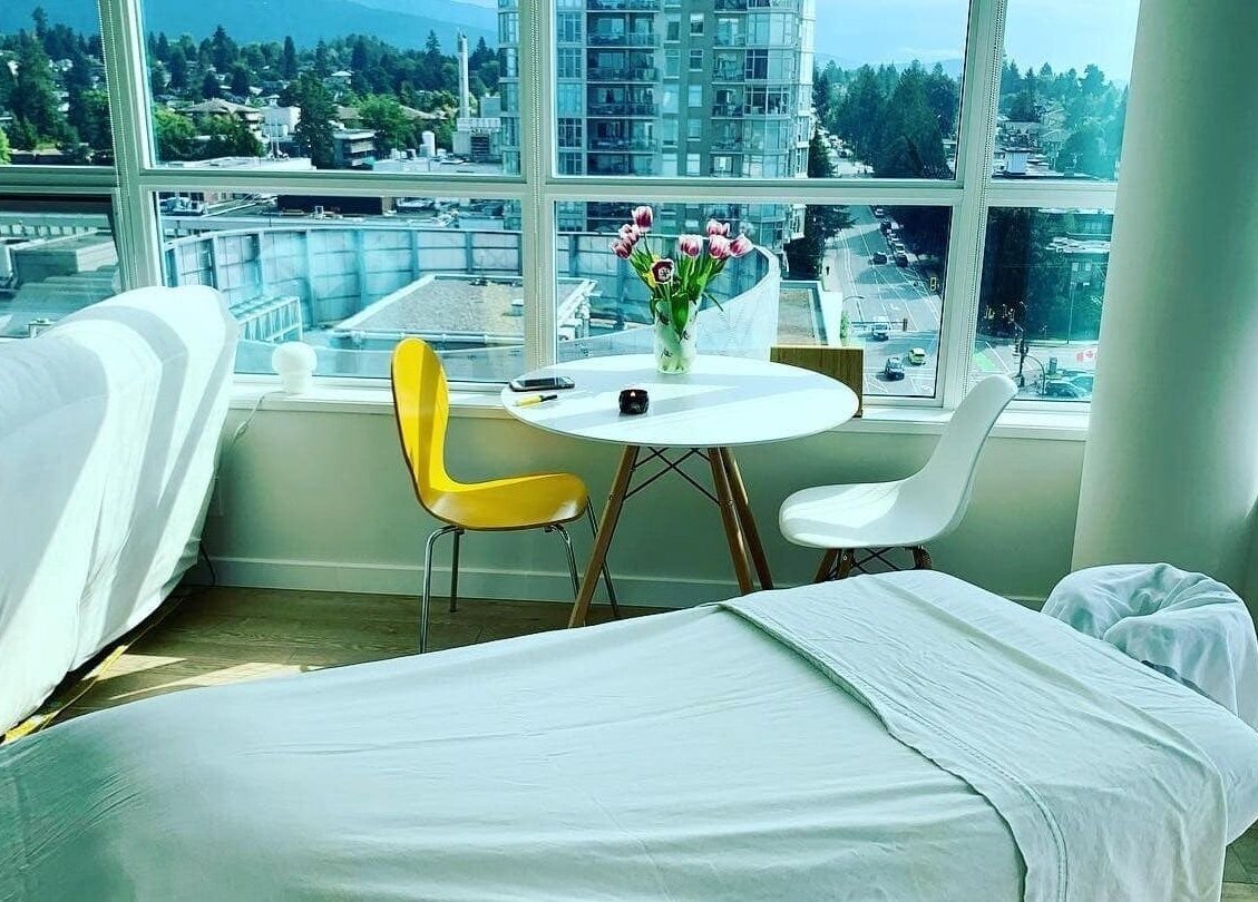 Relaxing massage room at En Vie Mobile Massage in Vancouver, British Columbia, CA, with city view.