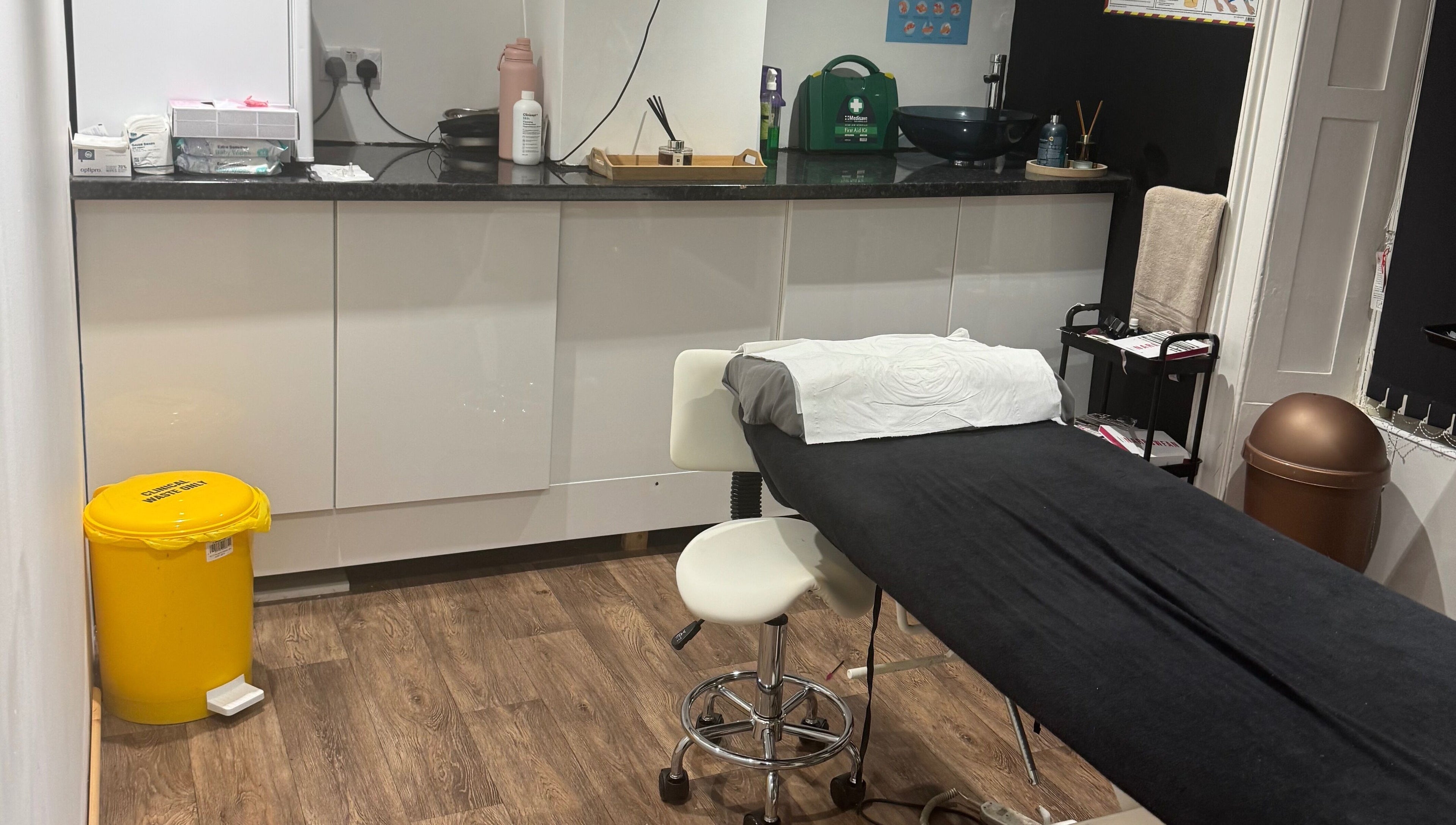 On The Lash Aesthetics treatment room in Wincanton, England, GB with a comfortable black massage table.