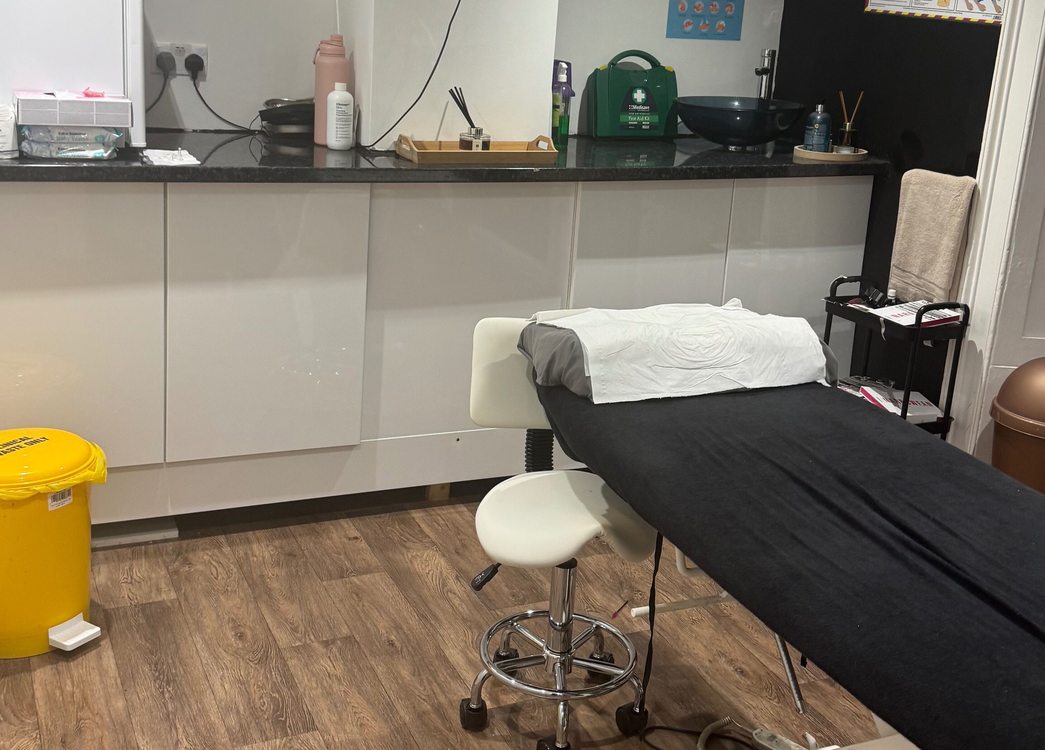 On The Lash Aesthetics treatment room in Wincanton, England, GB with a comfortable black massage table.