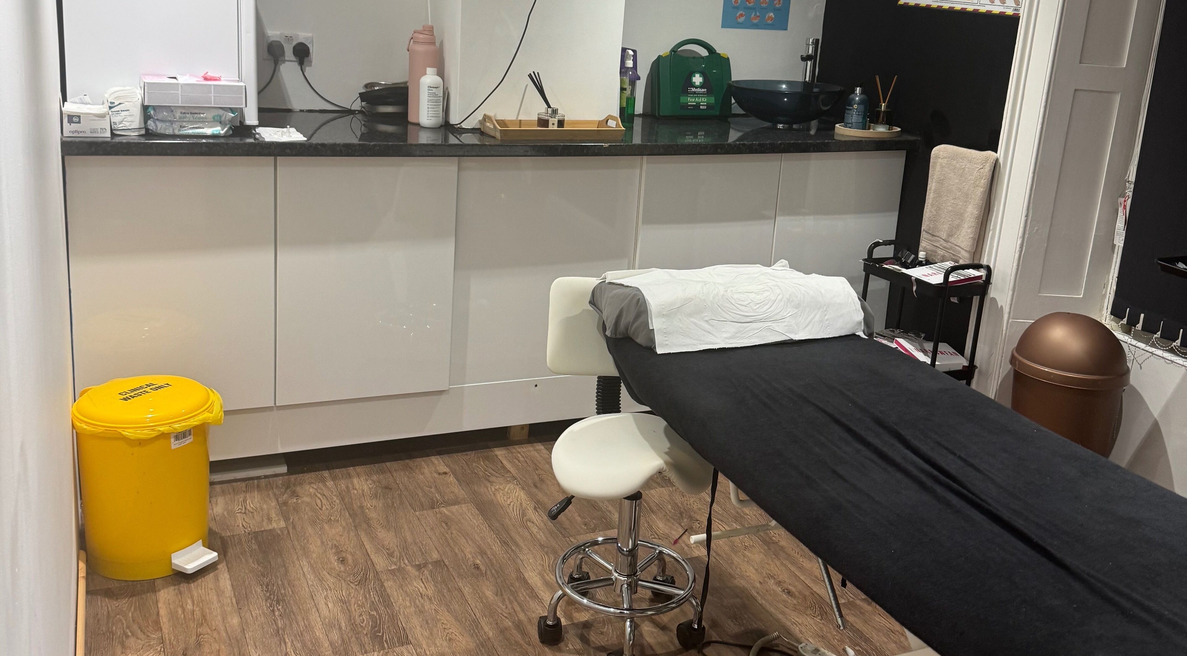 On The Lash Aesthetics treatment room in Wincanton, England, GB with a comfortable black massage table.