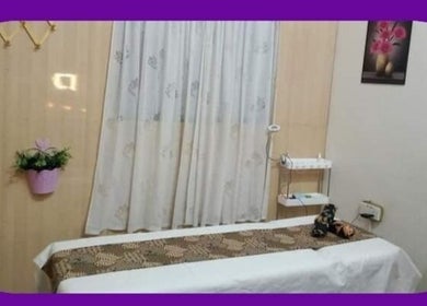 Relaxing massage table setup at Dmanja Salon, Pendang, Kedah, MY, adorned with elegant decor.
