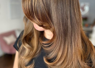 Elegant brunette hairstyle at Studio 58 at Deluxe, Maidstone, England, GB showcasing smooth waves.