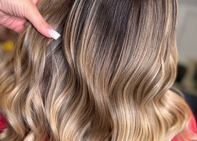 Elegant wavy hairstyle at Studio 58 at Deluxe, Maidstone, England, GB, showcasing vibrant blonde highlights.