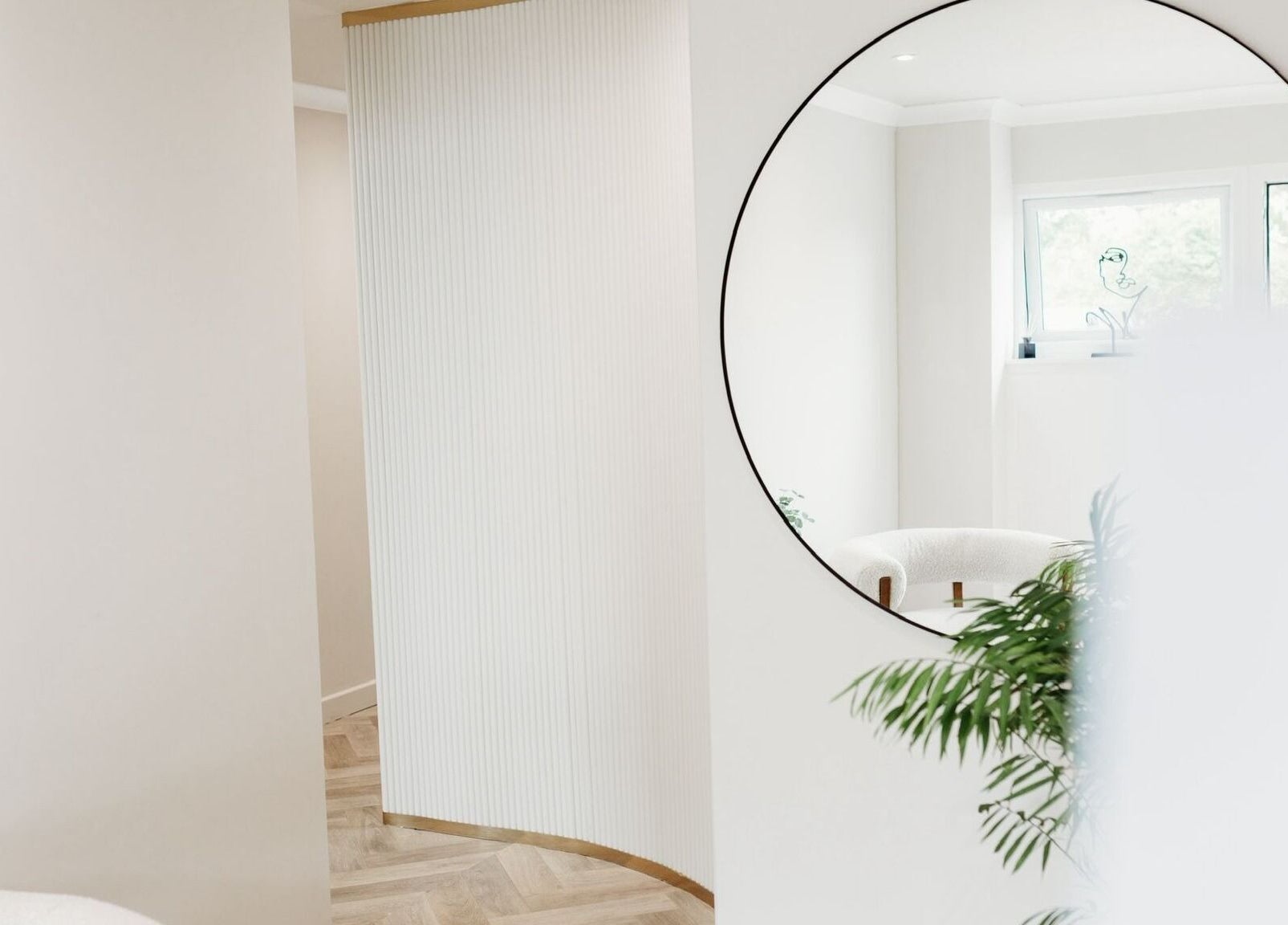 Elegant decor with a round mirror at Rachel Abbie (RA) Aesthetics HQ, Lelant, England, GB.