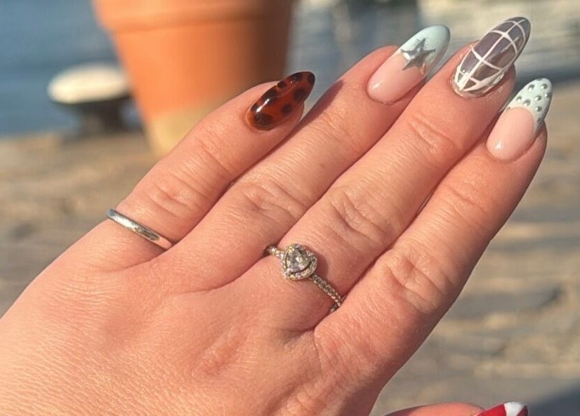 Artistic nail design from Nails by Lauren M in Morpeth, England, GB, showcasing intricate patterns under sunlight.